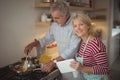 Senior couple preparing food in kitchen Royalty Free Stock Photo