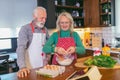 Senior couple preparing food in the kitchen Royalty Free Stock Photo