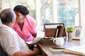 Senior Couple Putting Letter Into Keepsake Box