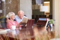 Senior Couple Putting Letter Into Keepsake Box