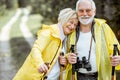 Senior couple in raincoats hiking in the forest Royalty Free Stock Photo