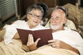 Senior Couple Reading in Bed Royalty Free Stock Photo