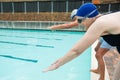 Senior couple ready to jump in swimming pool Royalty Free Stock Photo