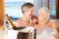 Senior Couple Relaxing In Bath Drinking Champagne Together Royalty Free Stock Photo