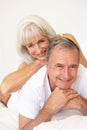 Senior Couple Relaxing On Bed Royalty Free Stock Photo