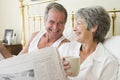 Senior couple relaxing in bed Royalty Free Stock Photo