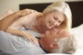 Senior Couple Relaxing On Bed Royalty Free Stock Photo