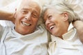 Senior Couple Relaxing In Bed Royalty Free Stock Photo