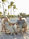 Senior Couple Relaxing On Deckchairs At Beach Royalty Free Stock Photo