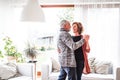 Senior couple relaxing at home, dancing.