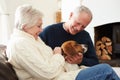 Senior Couple Relaxing At Home With Pet Dog Royalty Free Stock Photo