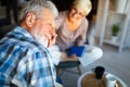 Mature couple relaxing at home and reading book together Royalty Free Stock Photo