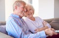 Senior Couple Relaxing At Home Sitting On Sofa Watching Television Together Royalty Free Stock Photo