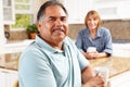 Senior couple relaxing in kitchen Royalty Free Stock Photo