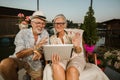 Couple relaxing outside and using tablet, making video call Royalty Free Stock Photo