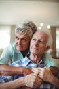 Senior couple relaxing on sofa in living room Royalty Free Stock Photo