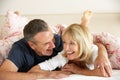 Senior Couple Relaxing Together In Bed Royalty Free Stock Photo