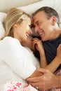 Senior Couple Relaxing Together In Bed Royalty Free Stock Photo
