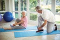 Senior couple removing their shoes at home