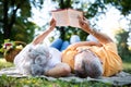 Senior couple resting at park, reading a book Royalty Free Stock Photo