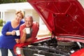 Senior Couple With Restored Classic Car Royalty Free Stock Photo