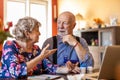 Senior couple reviewing drug prescription online