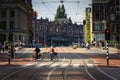 Senior couple riding bicycles across the street in Amsterdam, Netherlands