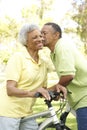 Senior Couple Riding Bikes In Park Royalty Free Stock Photo