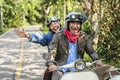 Senior couple riding a classic scooter Royalty Free Stock Photo