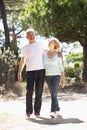 Senior Couple On Romantic Walk In Countryside Royalty Free Stock Photo