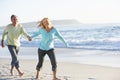 Senior Couple Running Along Beach Royalty Free Stock Photo