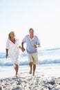 Senior Couple Running Along Beach Royalty Free Stock Photo