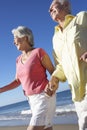 Senior Couple Running Along Beach Together Royalty Free Stock Photo