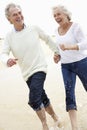 Senior Couple Running Along Beach Together Royalty Free Stock Photo