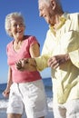 Senior Couple Running Along Beach Together Royalty Free Stock Photo