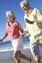 Senior Couple Running Along Beach Together Royalty Free Stock Photo