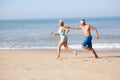 Senior couple running on beach Royalty Free Stock Photo