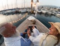 Senior couple on sailboat vacation - Happy elderly people having fun celebrating wedding anniversary on boat trip Royalty Free Stock Photo