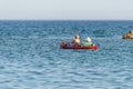 Senior couple sails in a canoe in the open sea