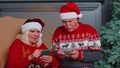 Happy senior family on mobile phone buy Christmas presents doing online ecommerce shopping purchase Royalty Free Stock Photo