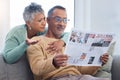 Senior couple, shocked and surprised by news while reading newspaper on sofa in living room at home together. Old man Royalty Free Stock Photo
