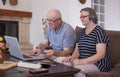 Senior couple shopping online using credit card on laptop Royalty Free Stock Photo