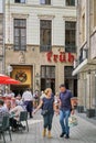 Senior couple enjoying a day of shopping in front of the famous Fruh Beer House in Cologne, Germany