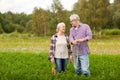 Senior couple with shovel picking carrots on farm Royalty Free Stock Photo