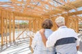 Sweet Senior Couple On Site Inside Their New Home Construction Framing