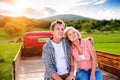 Senior couple sitting in back of red pickup truck Royalty Free Stock Photo