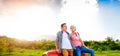 Senior couple sitting in back of red pickup truck Royalty Free Stock Photo