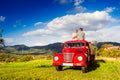 Senior couple sitting in back of red pickup truck Royalty Free Stock Photo