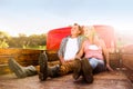 Senior couple sitting in back of red pickup truck Royalty Free Stock Photo