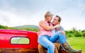 Senior couple sitting in back of red pickup truck Royalty Free Stock Photo